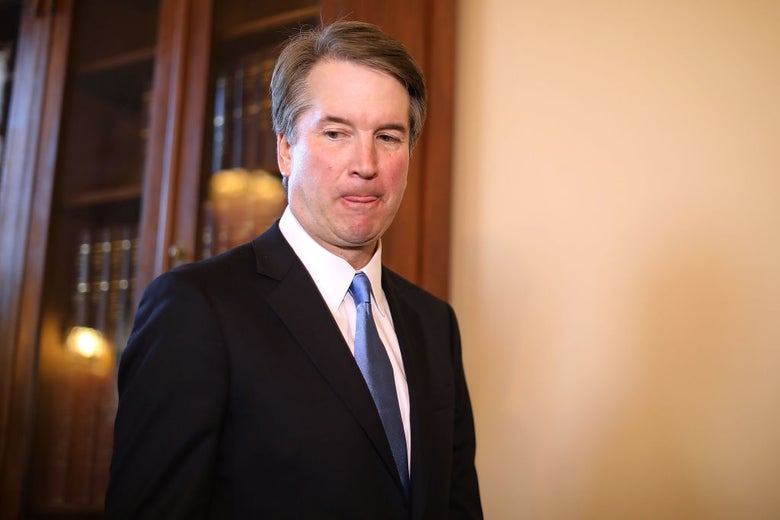 Kavanaugh looks down and to his right against the backdrop of a Capitol Hill office.